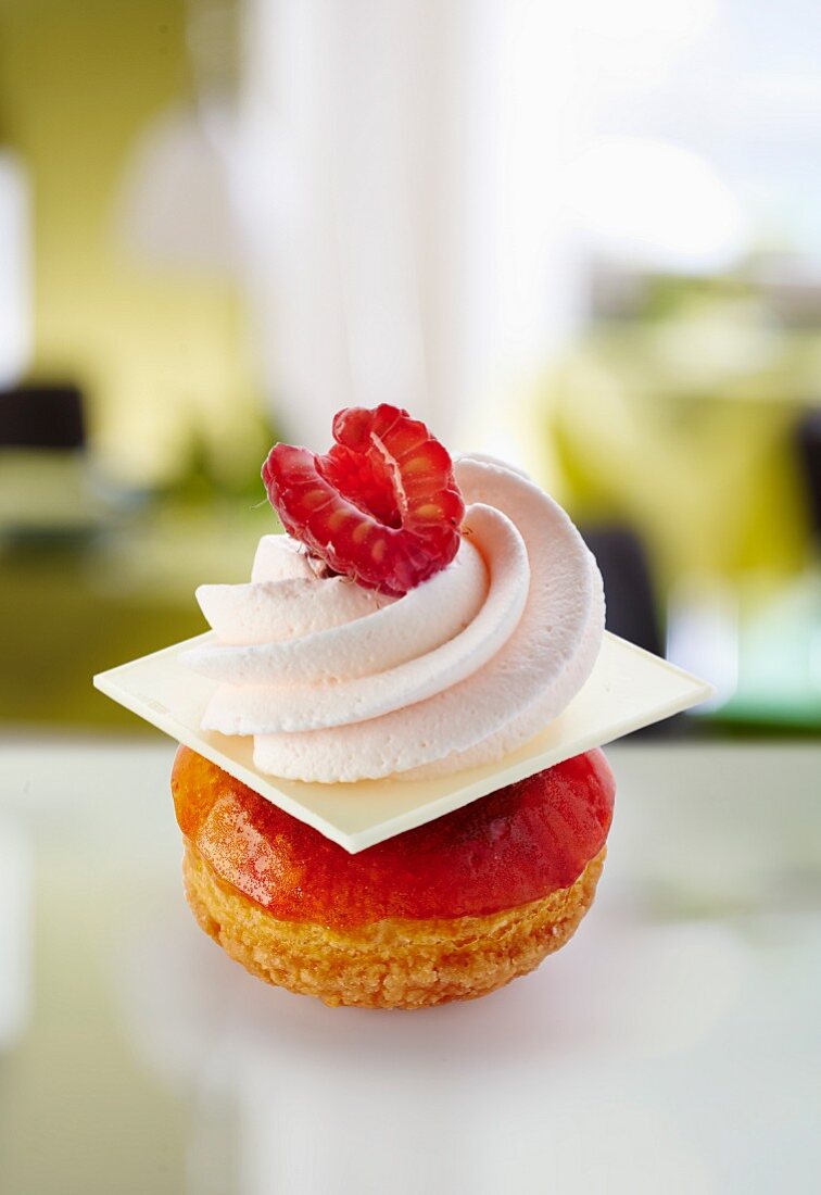 Mini Saint-Honoré cakes with white chocolate, cream and raspberries