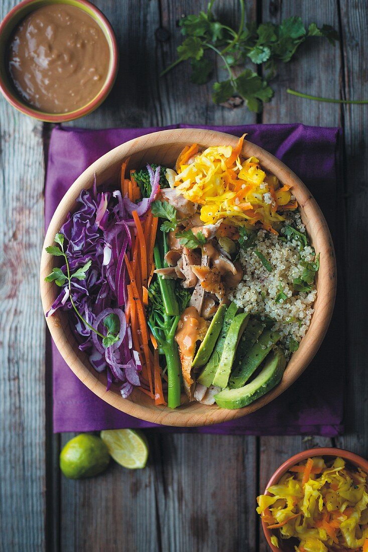 Power Bowl mit Quinoa, Huhn, Avocado, Gemüse und Erdnussdip