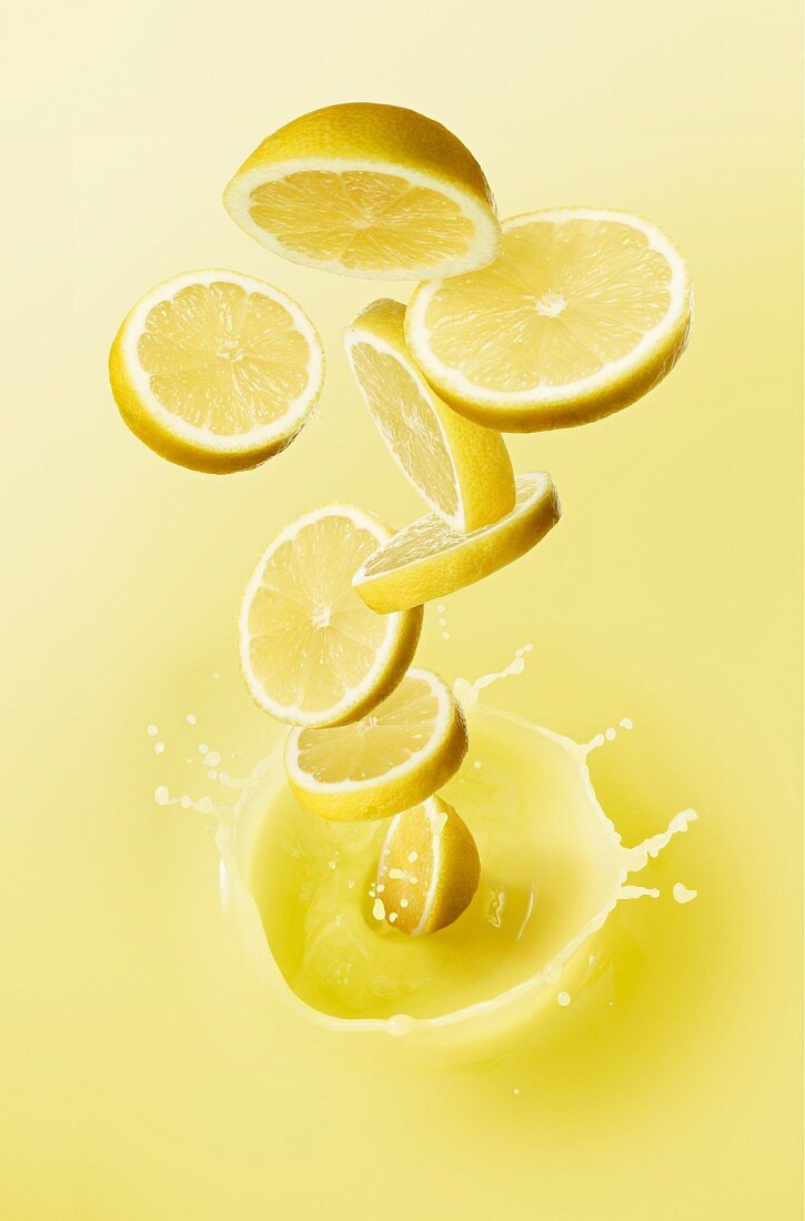 Lemon slices falling into lemon juice