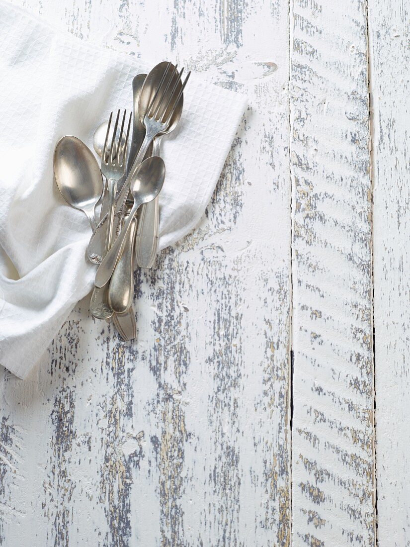 Old silver cutlery on a napkin