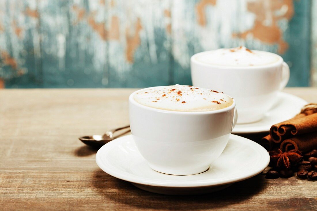 Two cups of coffee on old wooden table