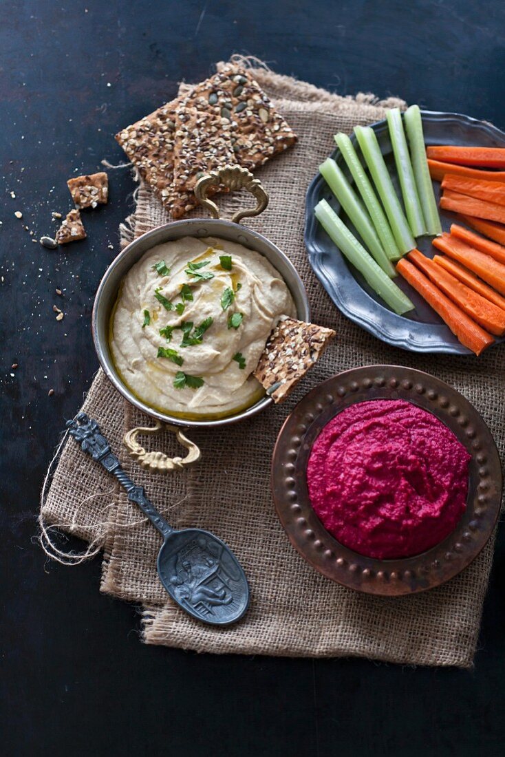Hummus and beetroot hummus with crisp bread, carrots and celery