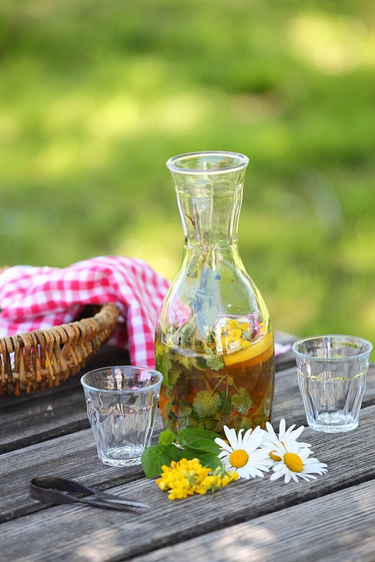 Selbst angesetzte Limonade mit Apfelsaft, Wildpflanzen und Zitronen