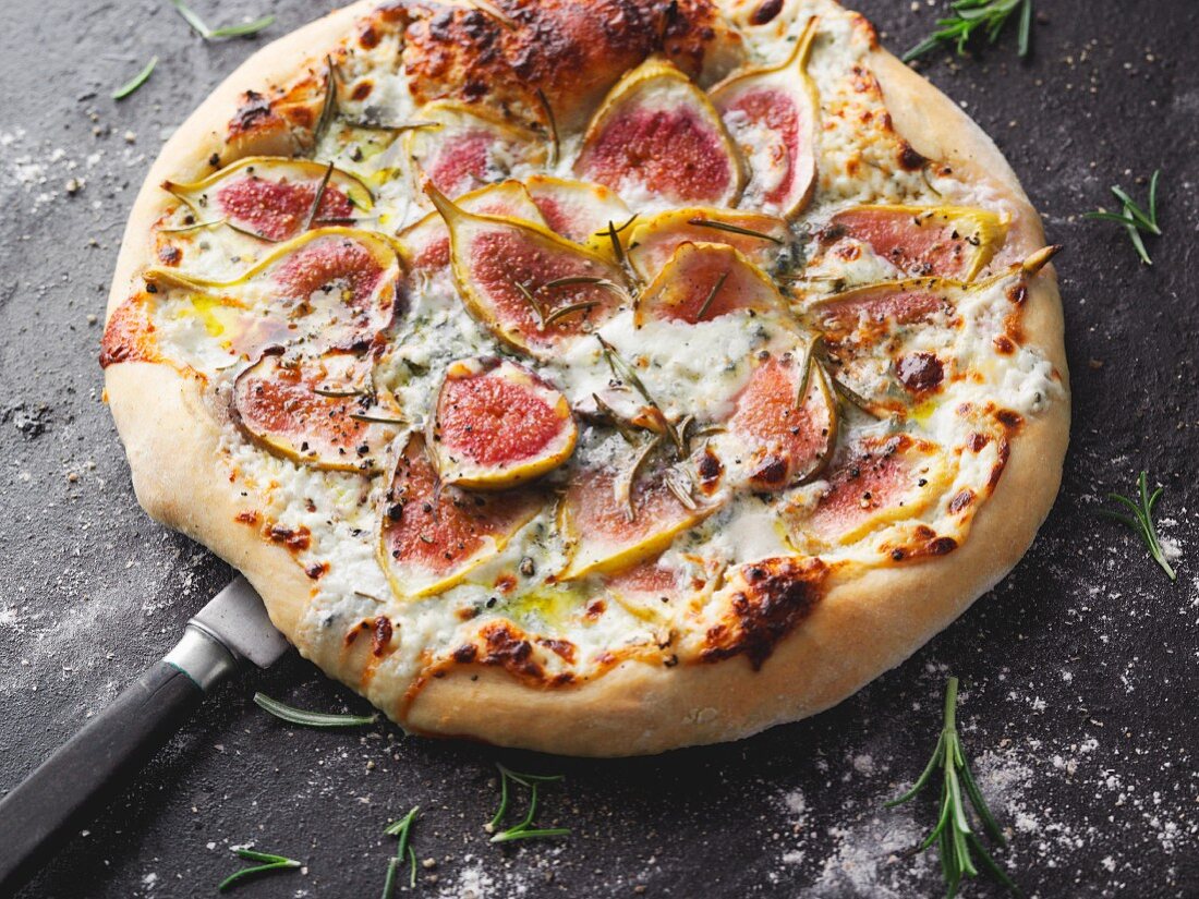 A pizza with gorgonzola, fresh figs and rosemary