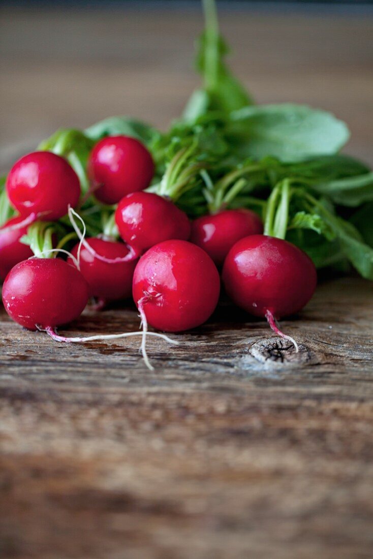 Fresh radishes on the rustic wooden table