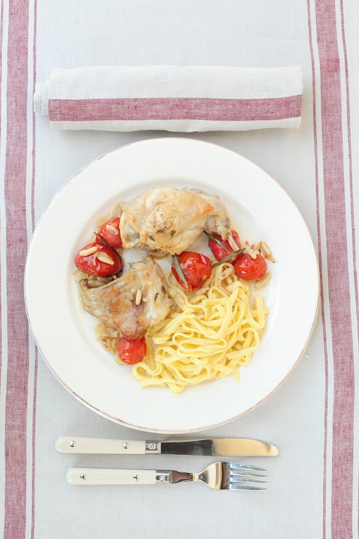 Rabbit with cherry tomatoes and ribbon noodles (top view)