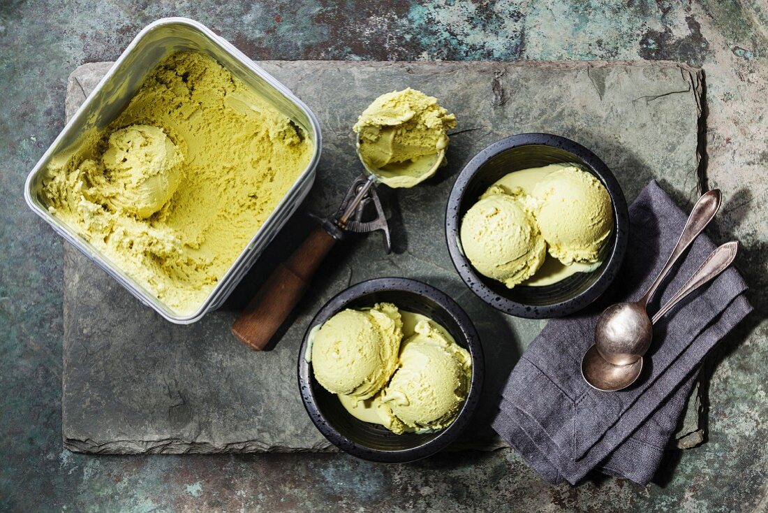 Ice cream Green tea with mint leaves and Spoon for ice cream on stone slate background