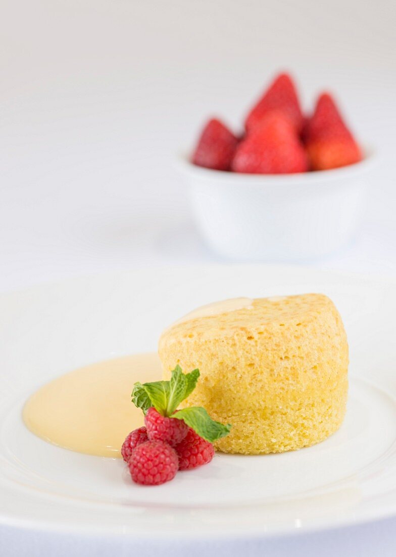 Sponge pudding, custard and strawberries