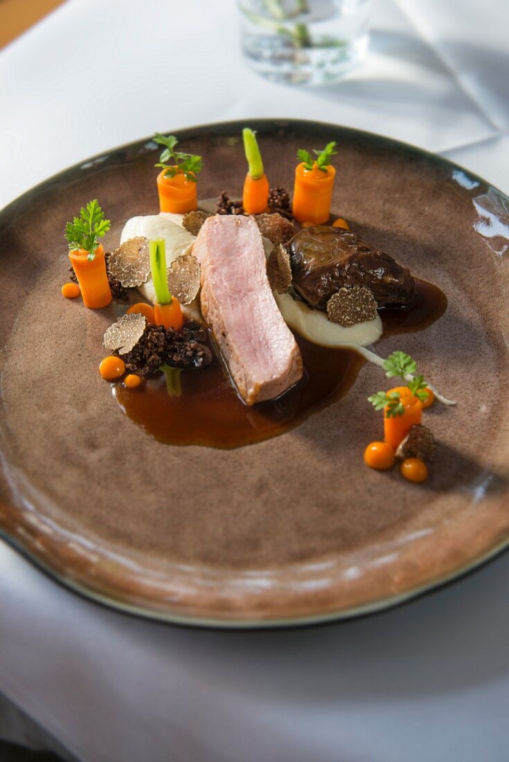 Saddle of suckling calf and calf cheek with truffle, pumpernickel bread, carrot and celery puree from the 'Platzhirsch' restaurant in Salzburg, Austria