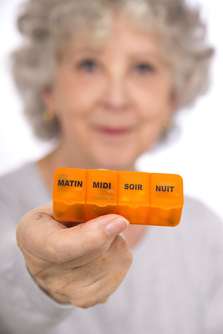 Woman holding pill organiser