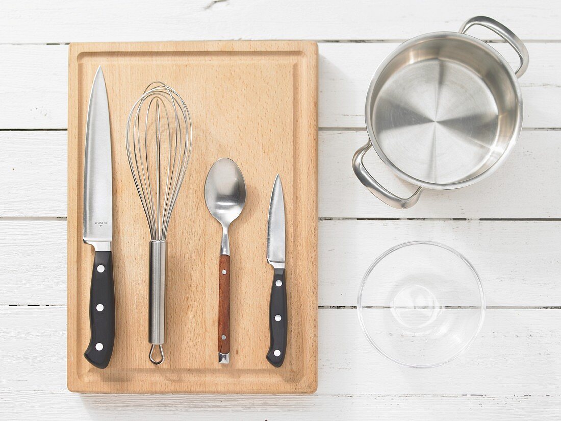 Kitchen utensils: pot, glass bowl, knife, whisk, spoon