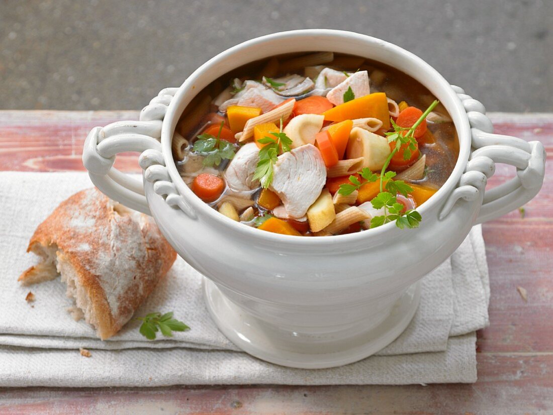 Grandmother's style chicken soup with vegetables and wholegrain noodles
