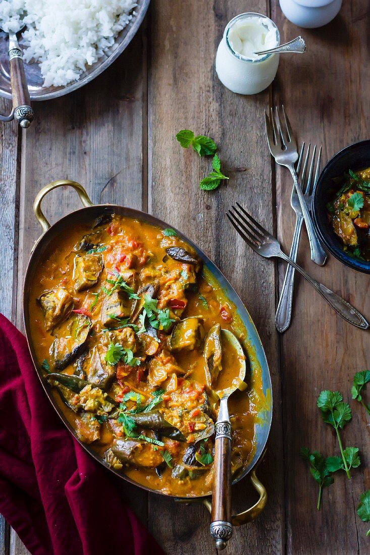 Aubergine curry with coriander in a serving dish