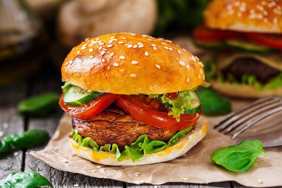 Vegetarian burger with grilled champignon, tomato and cucumber