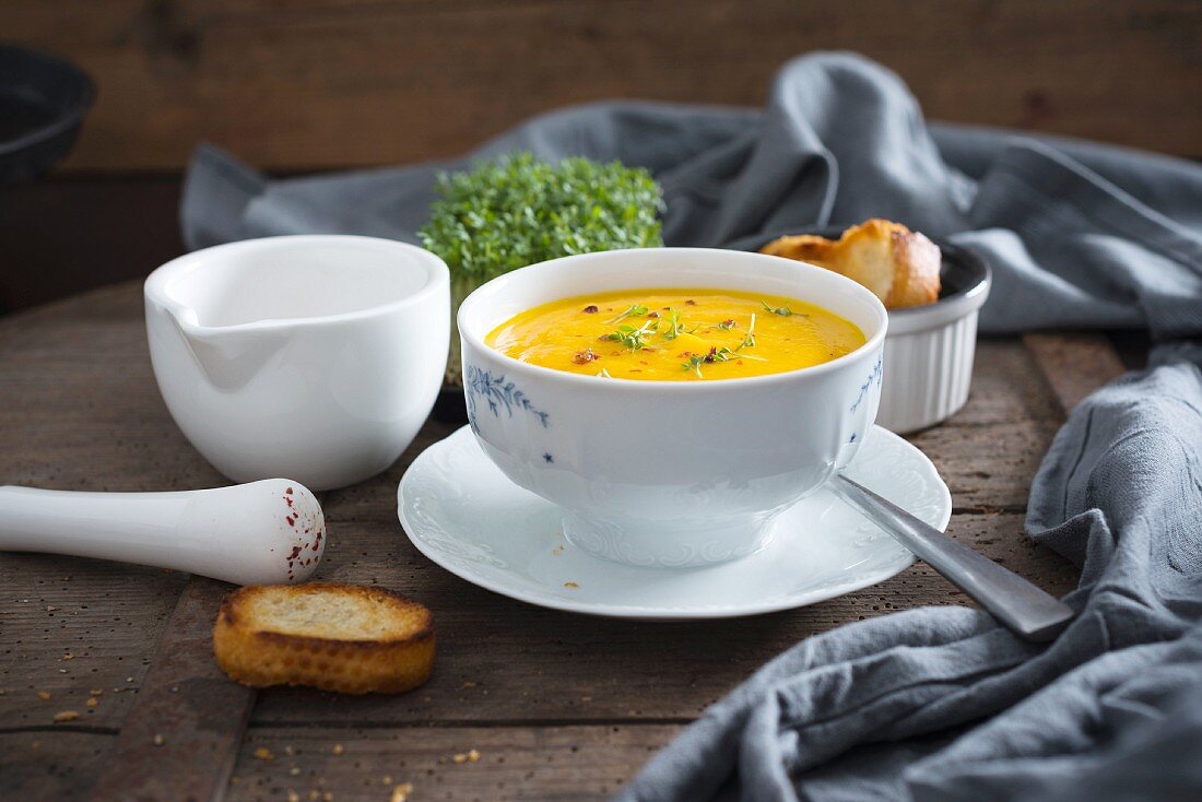 Vegan carrot soup with cress and red pepper