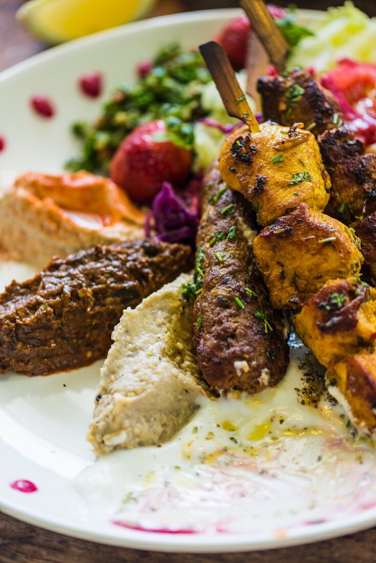 Moroccan kebabs with hummus and lettuce