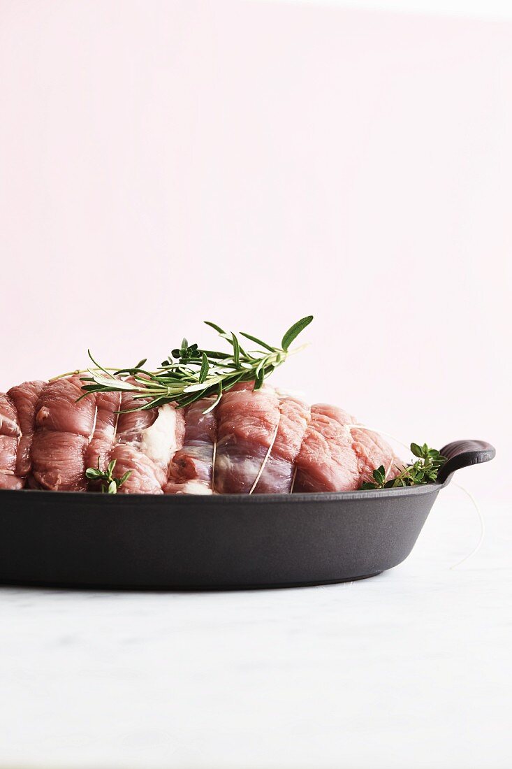 Rolled roast lamb in a roasting tin