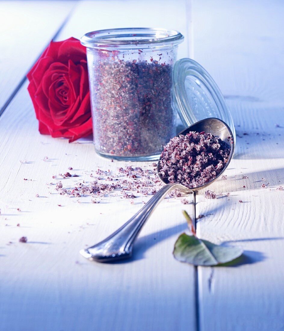 Rose salt in a glass and on a spoon with a rose