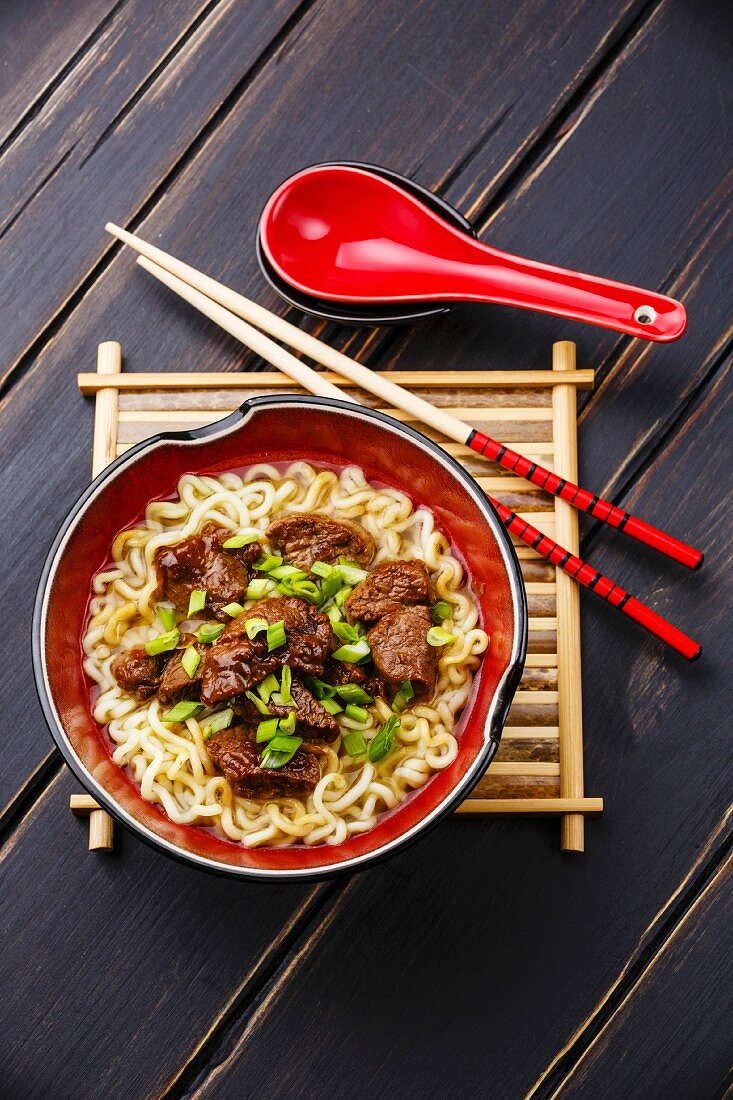 Miso Ramen Asian noodles with beef on dark wooden background