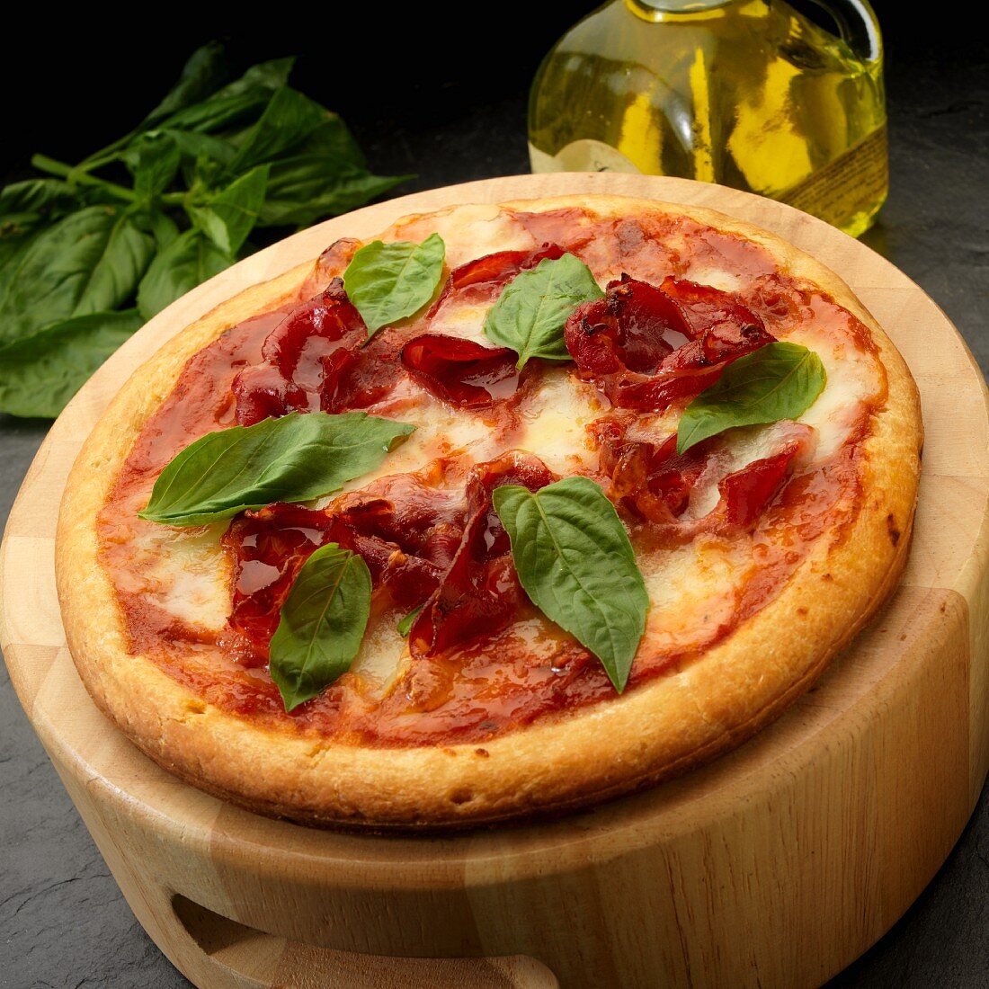 Pizza with tomato sauce, Capicola and mozzarella with basil leaves