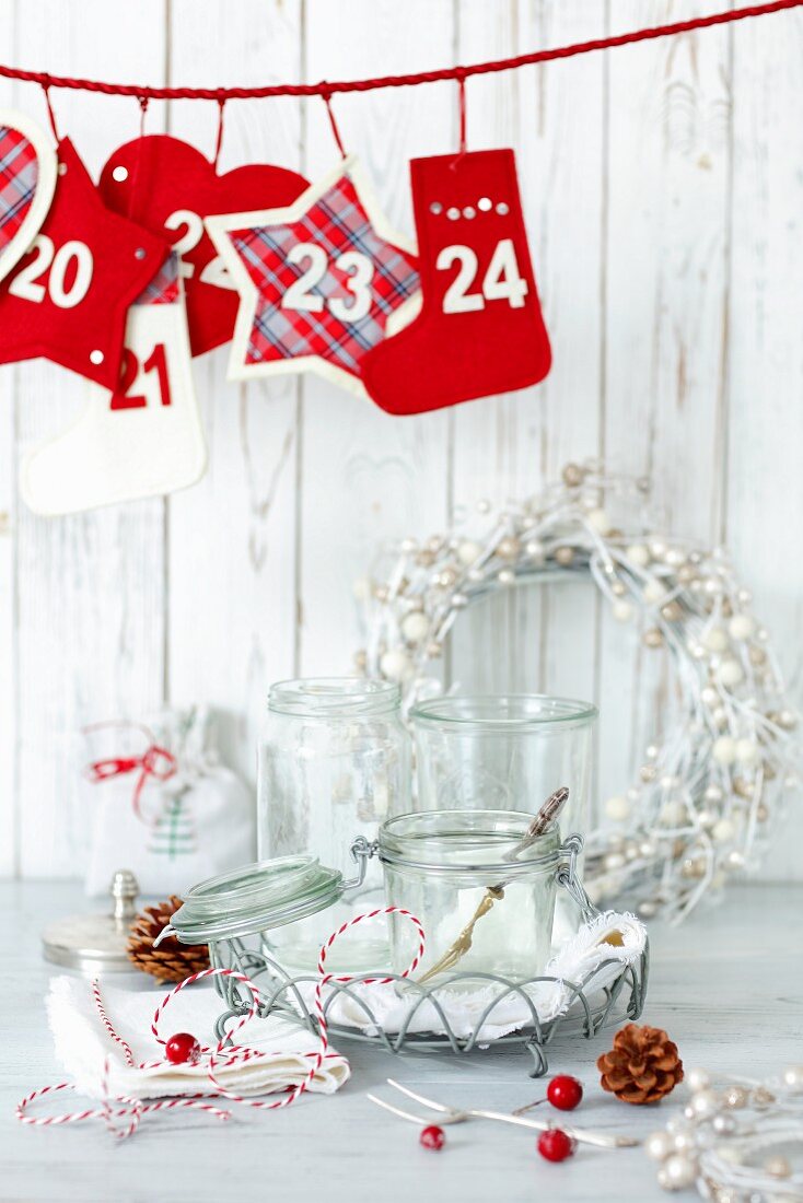 Christmas decorations and preserving jars on white table