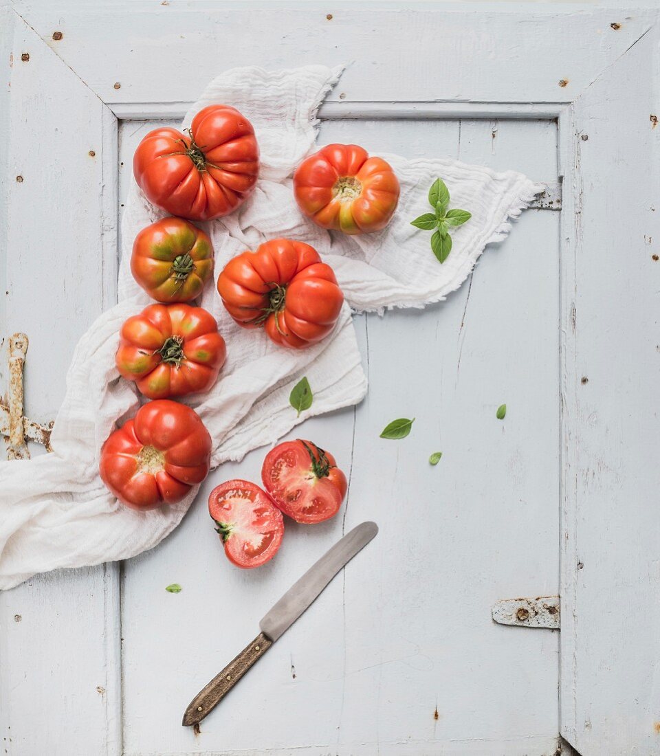 Fresh ripe hairloom tomatoes in rustuc blue wooden tray