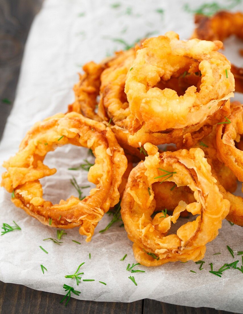 Homemade crunchy fried onion rings on a parchment