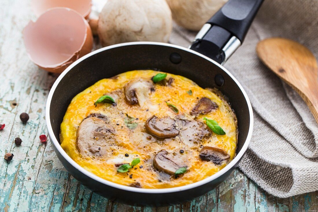 Homemade omelette with mushrooms in a pan