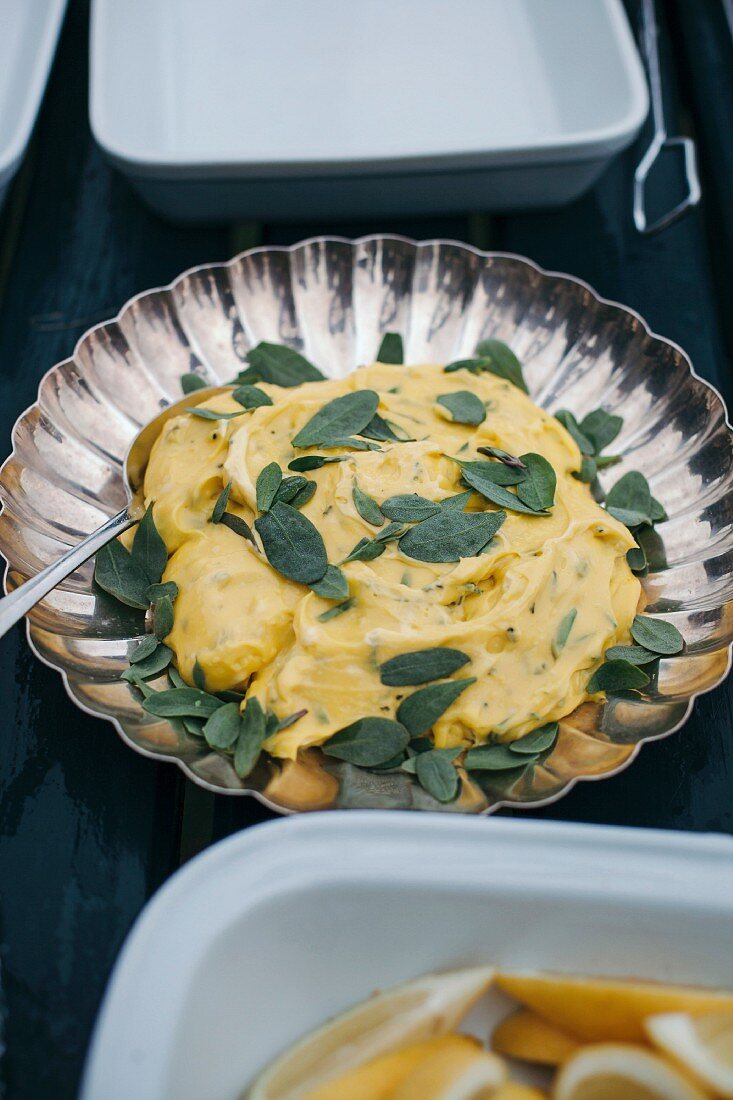 Homemade mayonnaise with sage leaves in a bowl
