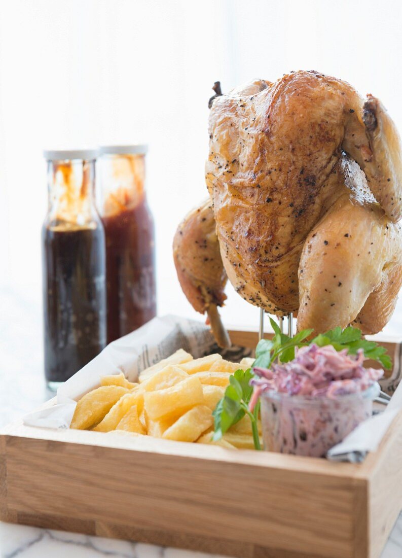 Roast chicken served standing, with chips