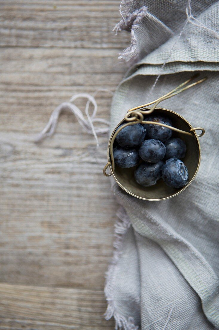Pot of Blueberries on Linen Cloth and Table