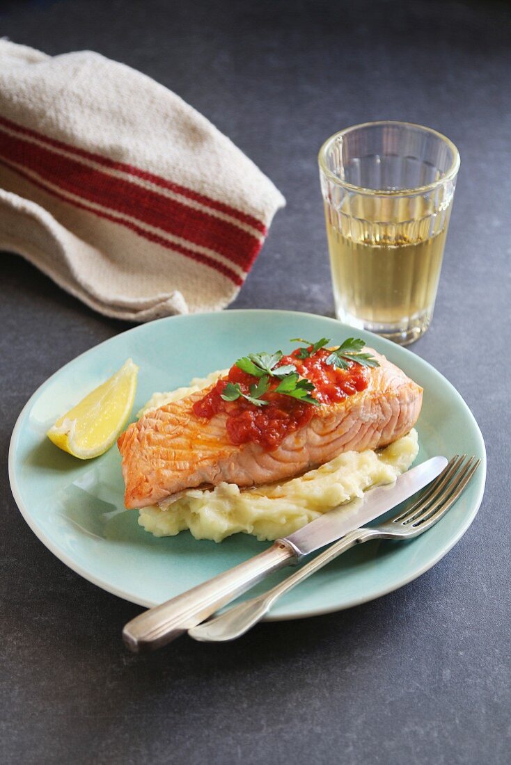 Fried salmon steak with mashed potatoes and garlic tomato sauce