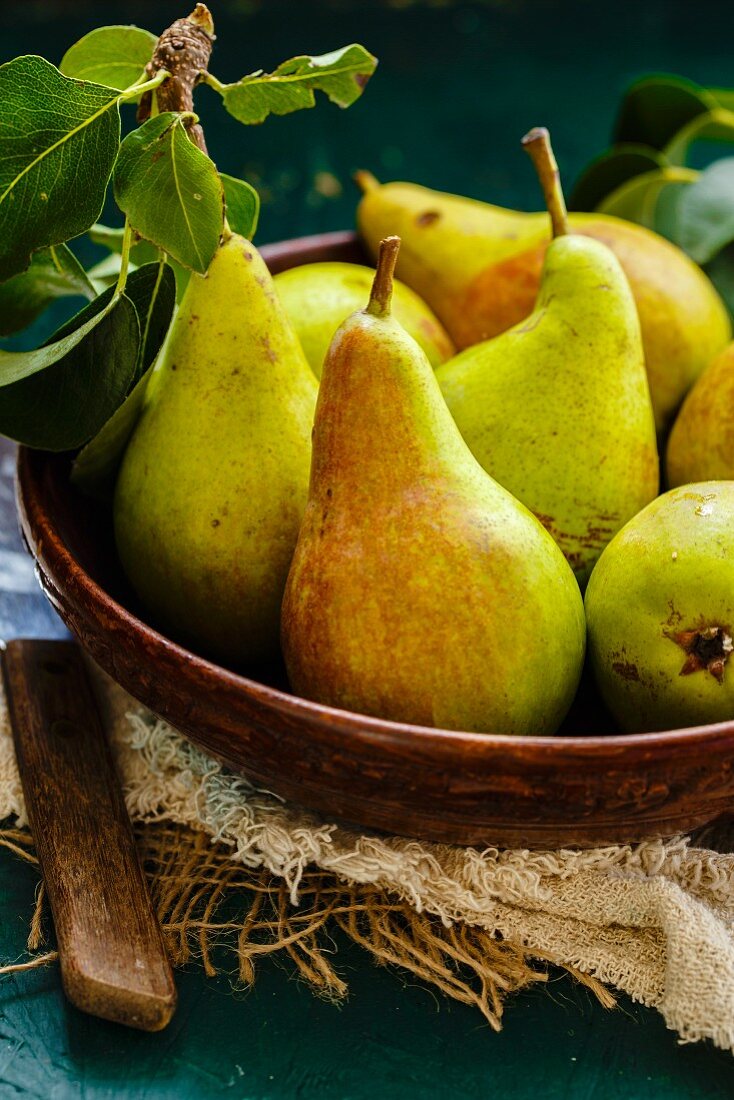 A wooden bowl of pears