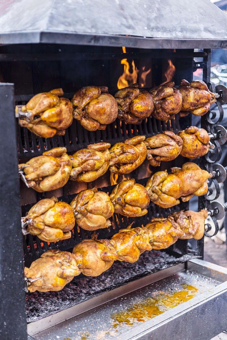 A grilled chicken stand at a market