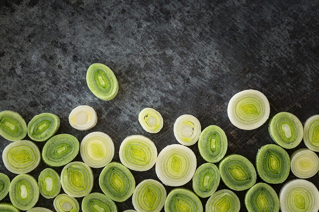 Leek slices on a grey stone surface