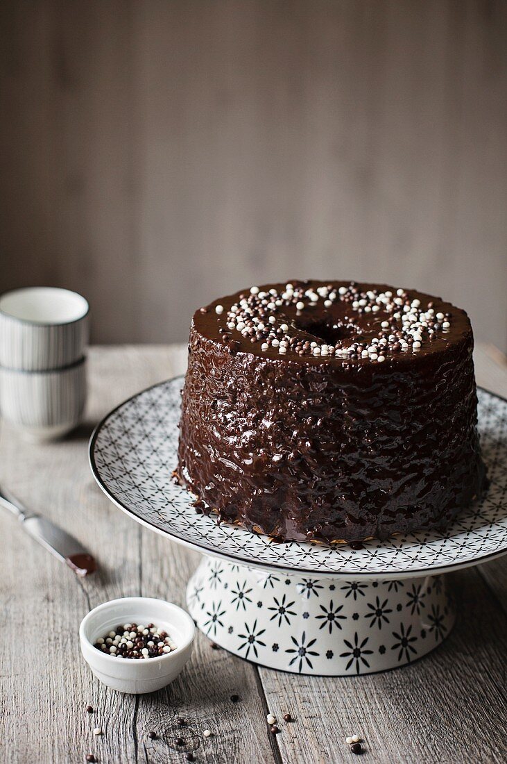 Marble chiffon cake with chocolate frosting on grey table