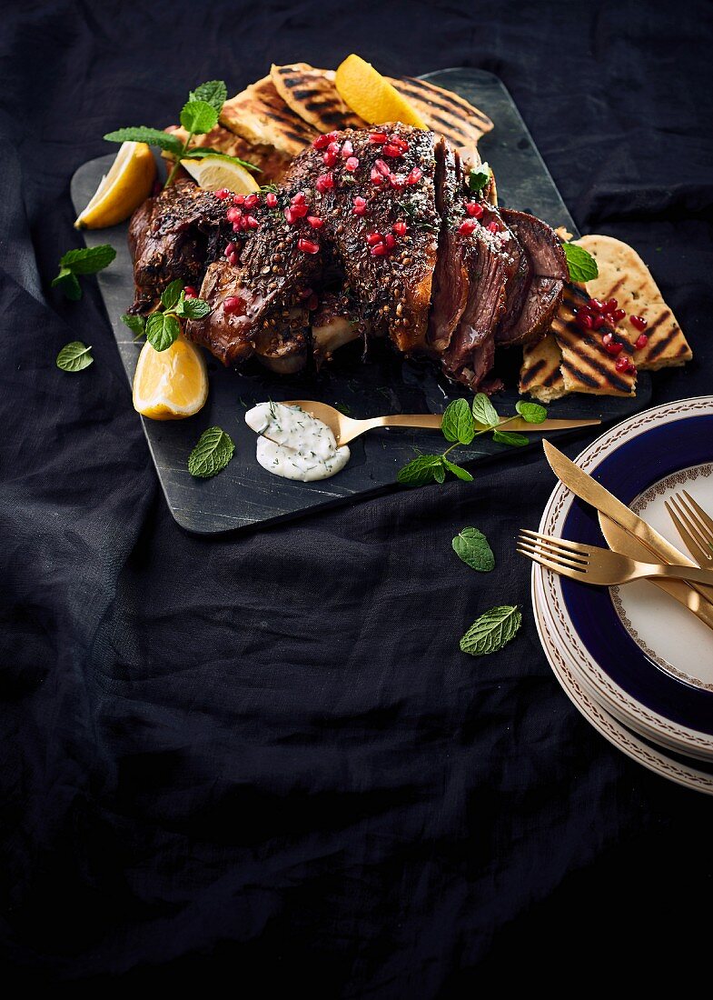 Spiced lamb with peppermint, pomegranate seeds, lemon and grilled bread