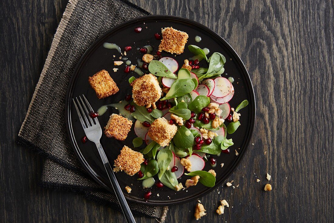 Purslane and radish salad with sesame tofu and pomegranate seeds