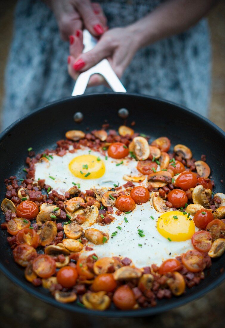 Egg, mushroom, tomato and chorizo hash in a sausepan