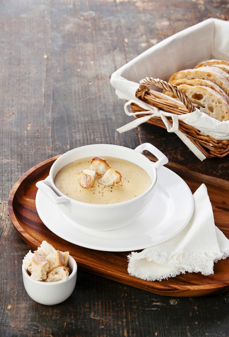 Cheese soup on textured wooden background