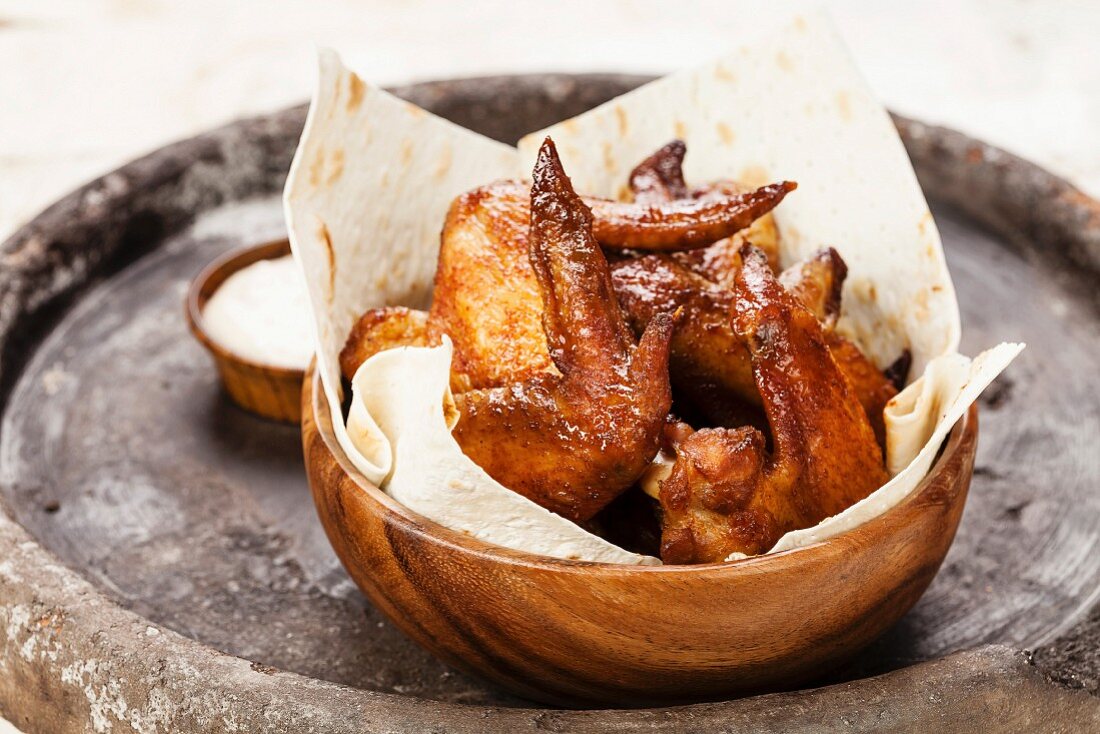 Fried Chicken Wings in wooden bowl