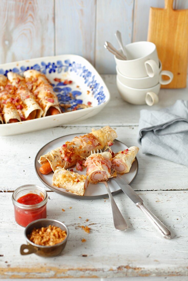 Tortilla hot dogs (sausage wrapped in tortilla, baked with cheese and bacon)