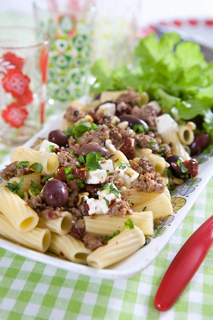 Pasta with minced meat, olives, feta, pine nuts, sun-dried tomatoes and chilli