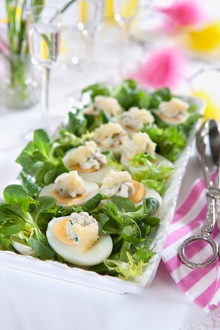 Easter hors d'oeuvres, egg, roe caviar, lettuce, snaps and easter decorations