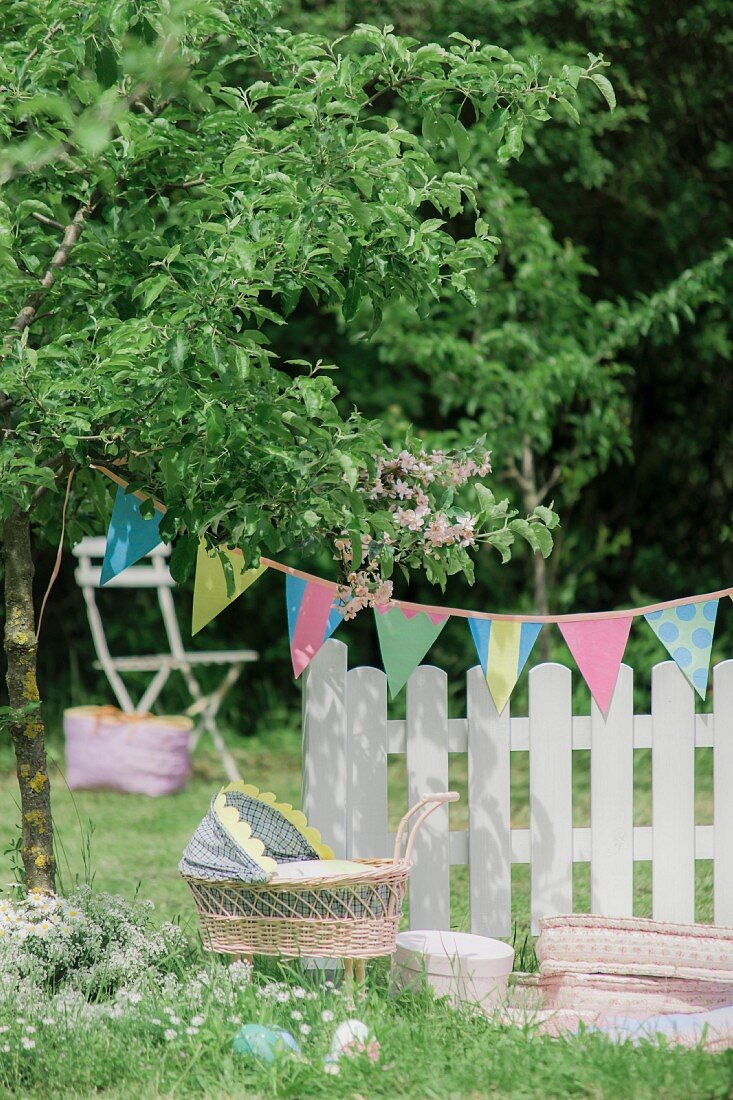 Dolls' pram and Easter eggs hidden for Easter picnic in garden