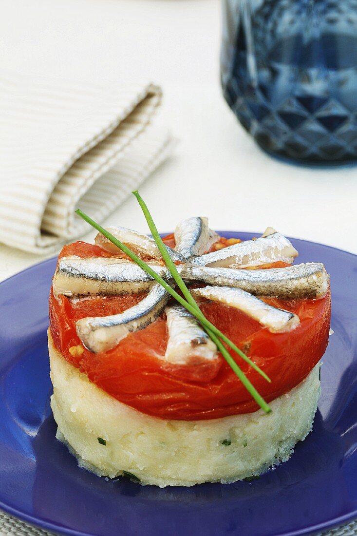 Tomato and anchovies with mashed potatoes