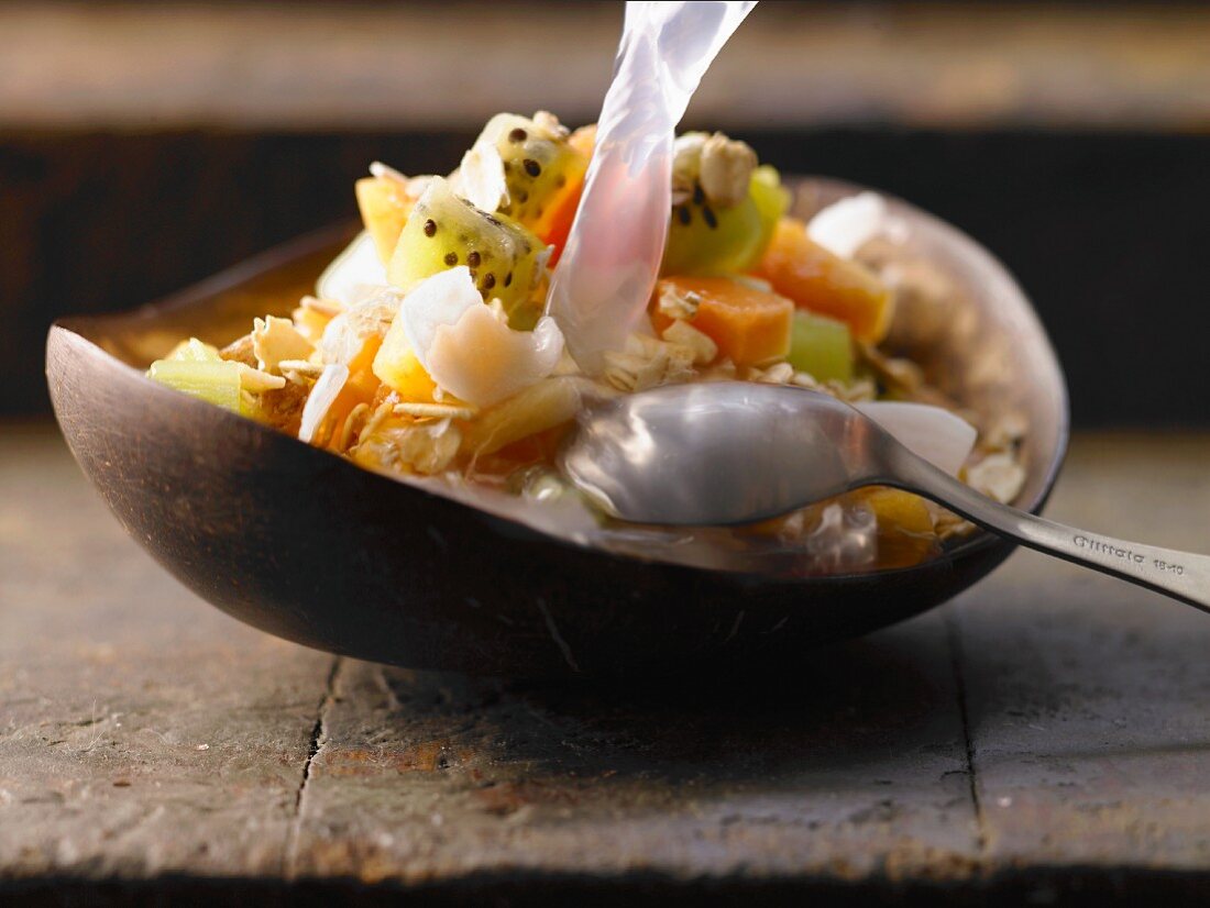 Exotic muesli with papaya, kiwi, kaki and coconut