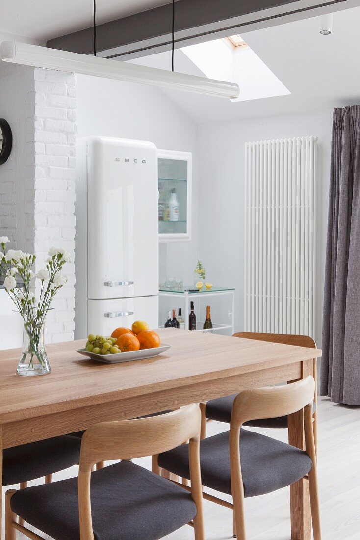 Scandinavian-style wooden chairs and dining table in kitchen