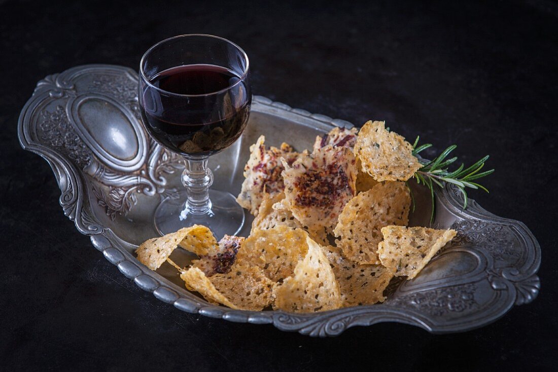 Cheese crisps and a glass of red wine
