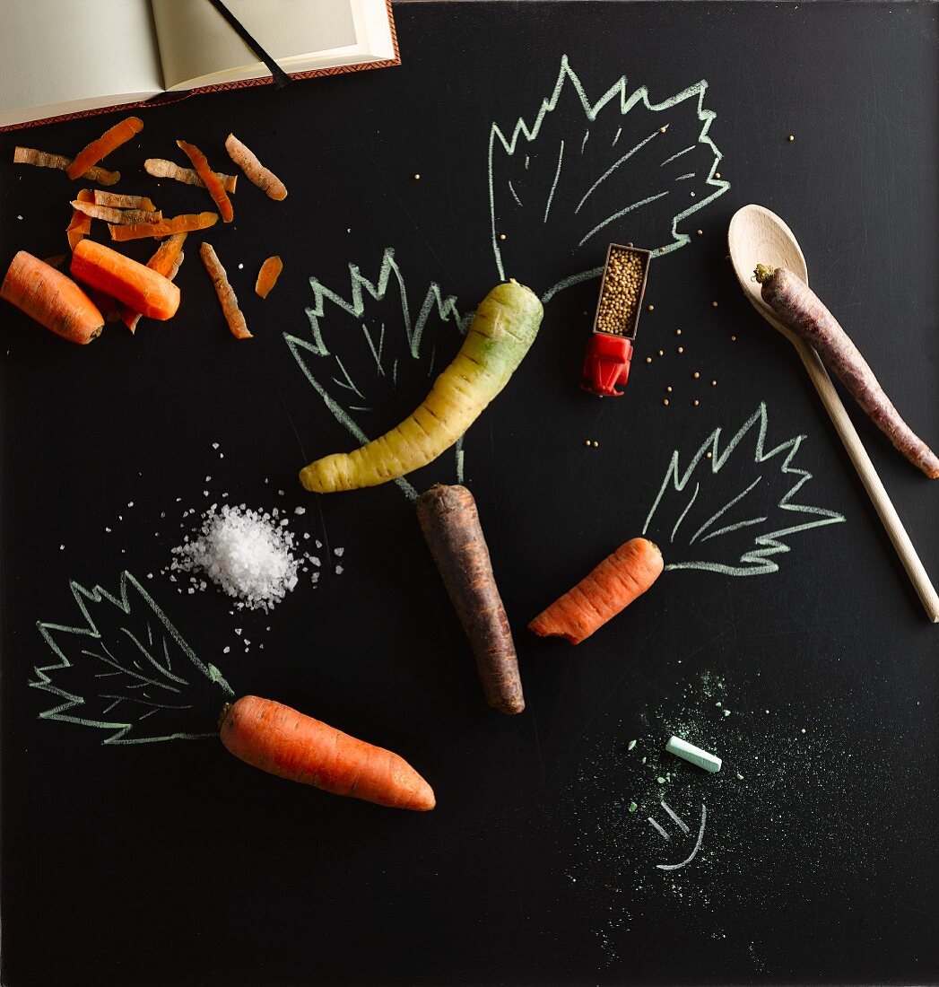 Various carrots with an illustration of carrot tops